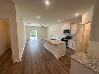 Kitchen featuring white cabinetry, a kitchen islan