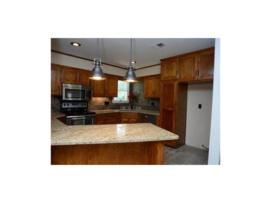 Remodeled kitchen with granite countertops, stainl
