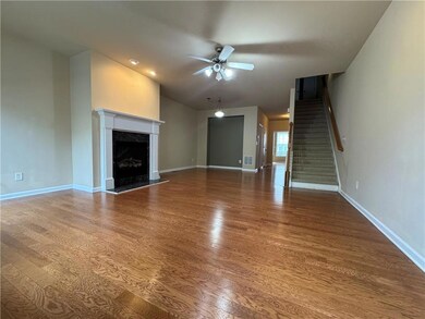 Unfurnished living room featuring a ceiling fan, w