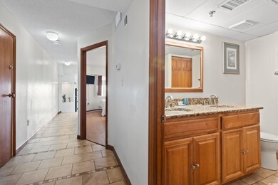 Bathroom with tile patterned floors, vanity, and t
