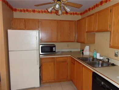Kitchen showing refrigerator and microwave that is