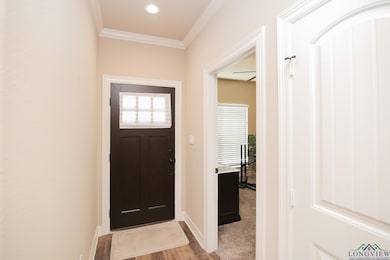 Foyer featuring ornamental molding, light wood-style flooring, and recessed lighting
