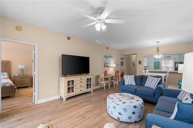 Living room featuring baseboards, visible vents, l