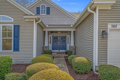 Doorway to property featuring roof with shingles a