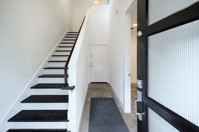 [Front Entry] Foyer with bedroom on right, door to