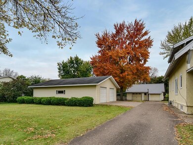Asphalt driveway.  Two detached garages.  Older ga