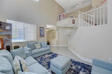 Living area featuring baseboards, a high ceiling,