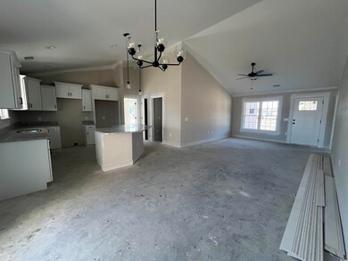 Kitchen featuring white cabinetry, decorative ligh