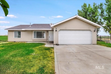 Ranch-style home with a front lawn, driveway, an attached garage, and roof with shingles