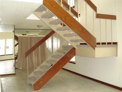Open staircase leading to loft bedroom