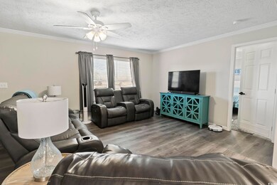 Living room with hardwood / wood-style floors, a t