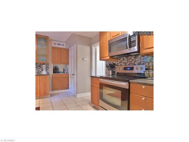 Beautiful glass tile backsplash accents this beaut