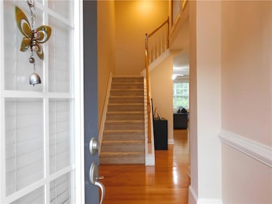 Stairway featuring wood finished floors