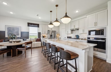 Bright kitchen with an expansive center island perfect for gatherings *Model representation
