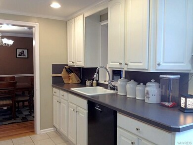 Kitchen with ceramic tile flooring and white cupbo