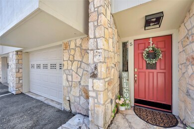 Doorway to property featuring stone siding and a 
