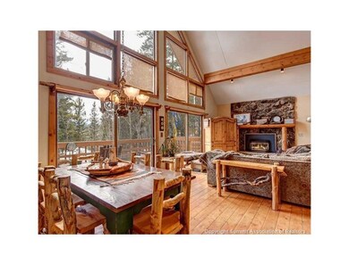 Living Room/Dining Room with 1 of 3 Stone Fireplac
