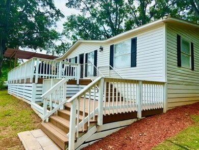 View of front of home featuring a deck and stairs