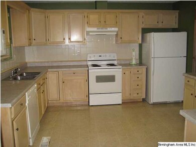 Large kitchen with lots of cabinets.