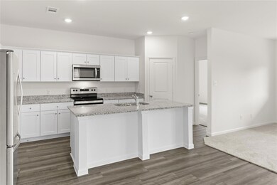 Kitchen with a center island with sink, appliances