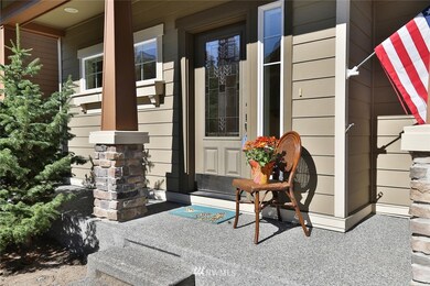 The beautiful front door, stone accents on the columns and porch is very inviting.  The porch has space for chairs and plants and is great place to get to know your neighbors.