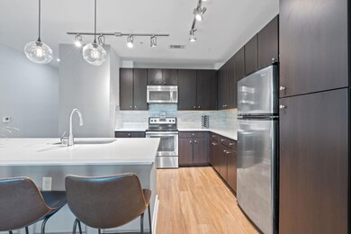 Kitchen with stainless steel appliances, light wo