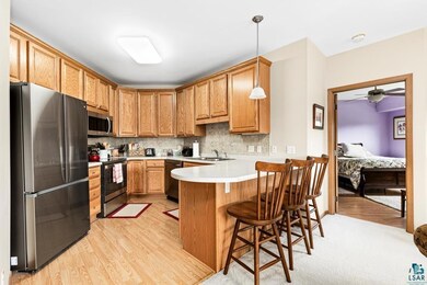 Kitchen with hanging light fixtures, light hardwoo