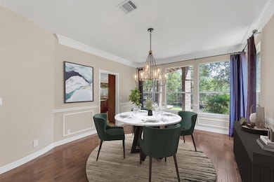 Dining area featuring a chandelier, dark wood-sty