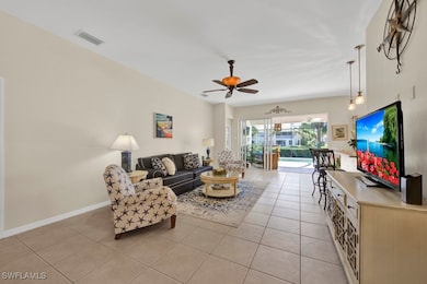 Living room with light tile patterned flooring, ba