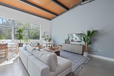 Living area featuring wooden ceiling, beamed ceil