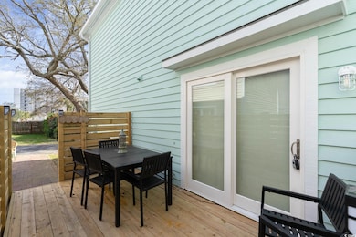 Wooden terrace with outdoor dining space and fence