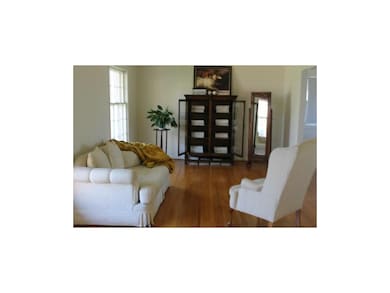 Lovely formal living room with hardwood floors.  A