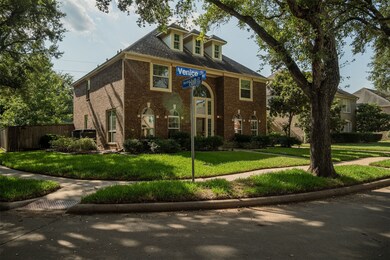 This traditional brick home with large windows and
