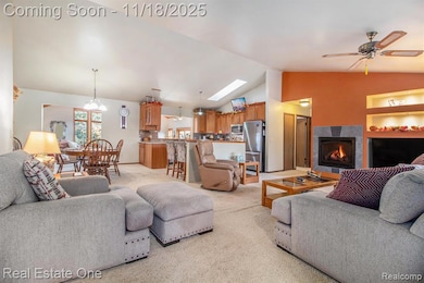 Living room with gas fireplace, vaulted ceiling and ceiling fan