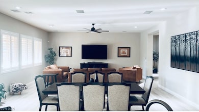 Dining room with light wood-style floors, baseboar