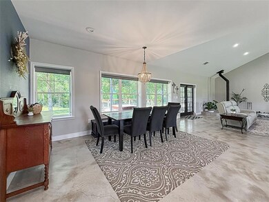 Dining space with baseboards, finished concrete f