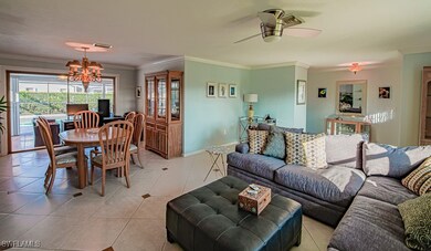 Living area featuring ceiling fan with notable cha