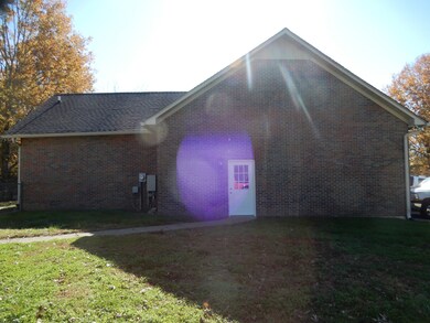 (Home) garage side entry with sidewalk leading to apartment