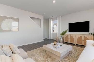 Living room featuring baseboards, recessed lighting, and wood finished floors