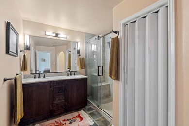 Full bathroom featuring a stall shower, double va