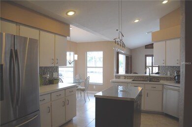 Kitchen with Stainless Steel Appliances, glass backsplash and Island with Stainless Steel top