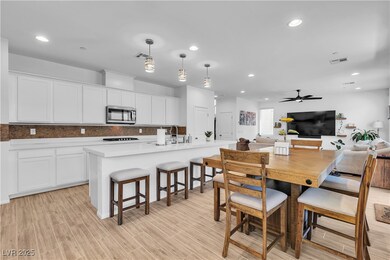 Dining area with recessed lighting, a ceiling fan,