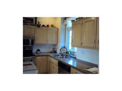 Kitchen has lots of cabinets and Granite Transform