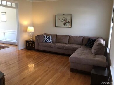 Spacious Formal Living Room with Crown Molding and