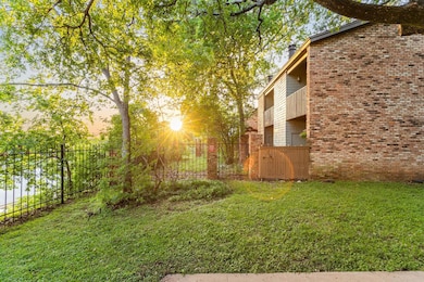 View of yard with a balcony and a gate