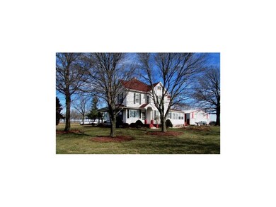 Surrounded by manicured, mulched mature trees