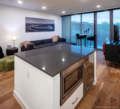 Kitchen featuring dark countertops, light wood-st