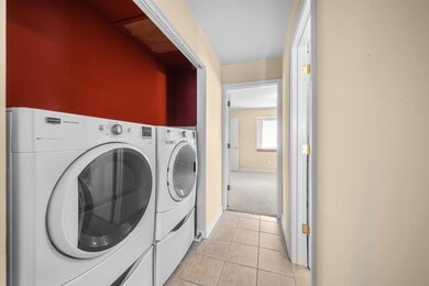 Laundry room featuring light tile patterned floors and separate washer and dryer