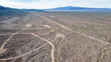 View of rural area featuring a mountainous background and a desert landscape