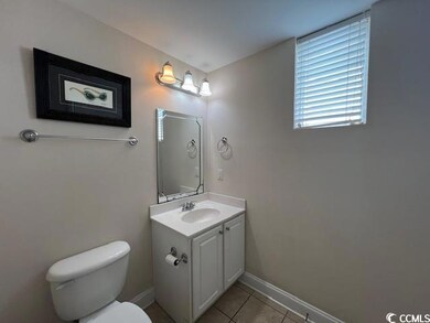 Bathroom featuring vanity, toilet, and tile patter